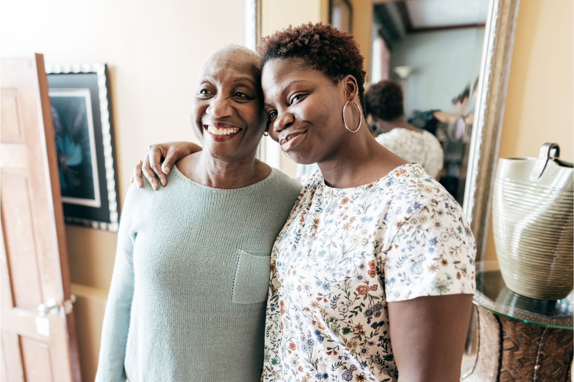 Two women standing next to each other in a room.