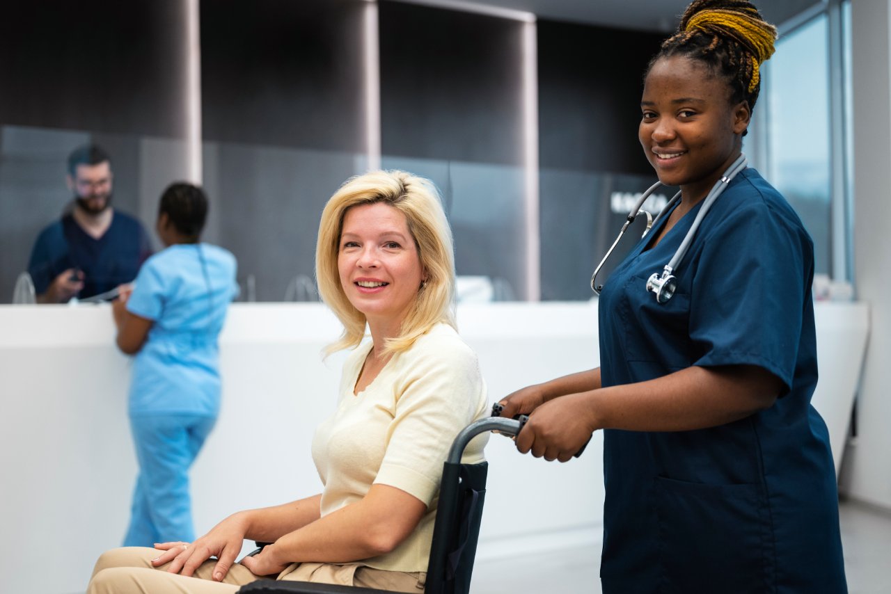 A woman in a wheelchair and a nurse